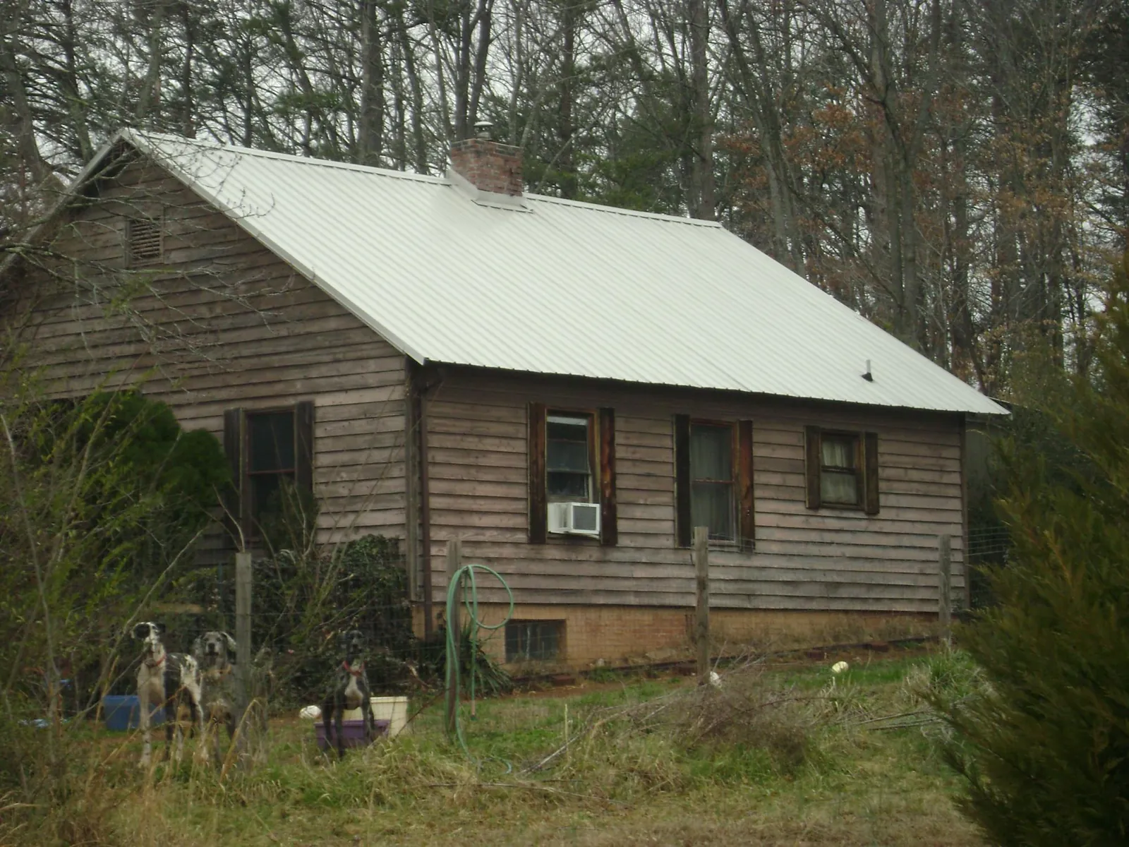 White metal roof on an old wood sided farmhouse, from a Metal Roof Installation job in Marshall